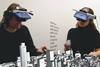 Seen through a third user’s “augmented reality glasses”, two team members alter a virtual urban landscape in real time.