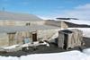 Scott’s hut at Cape Evans in Antarctica, showing the latrine and stables in the foreground.