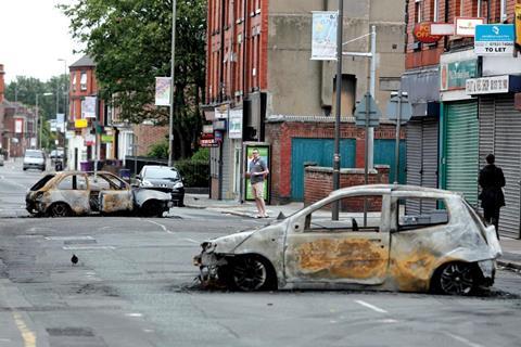 Burnt out cars in Toxteth, Liverpool, after rioting in the area Tuesday, August 9.