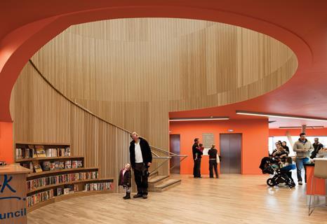 The library entrance is dominated by the sweeping spiral stairwell, lined with oak-veneered acoustic ribs.