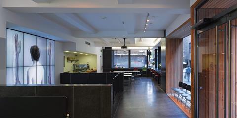 The ground floor café has been “carved out” and lined with black terrazzo.