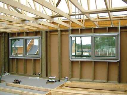 Windows are put in place as the house is constructed.
