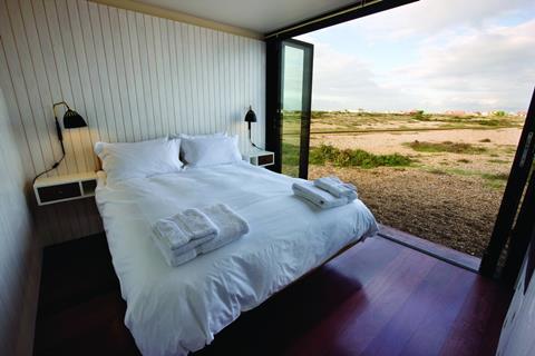 The bedrooms open directly on to the public beach.