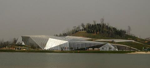 The Greenhouse. Visitors reach the shore by boat to discover the partially buried giant gem