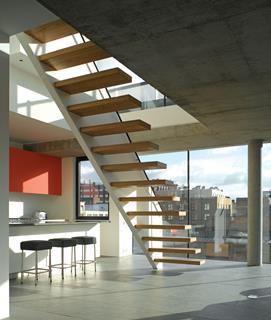 Stair leading to the top floor acts as a screen between the kitchen and main living area.