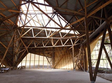 The primary structural trusses are of un-regularised larch roundwood.