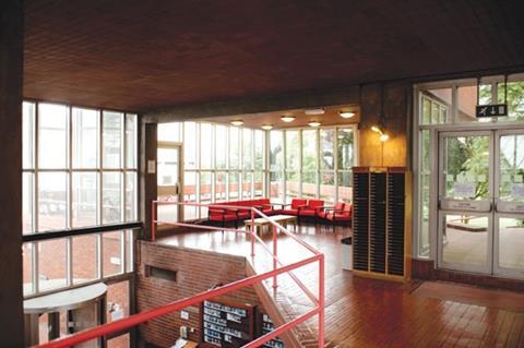 Pink handrails combine with terracotta tiling in one of the more generous landing areas in the tower.