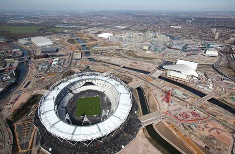 The stadium sits on its own island at the southern end of the Olympic Park. The Aquatics Centre and Orbit sculpture are to its right.