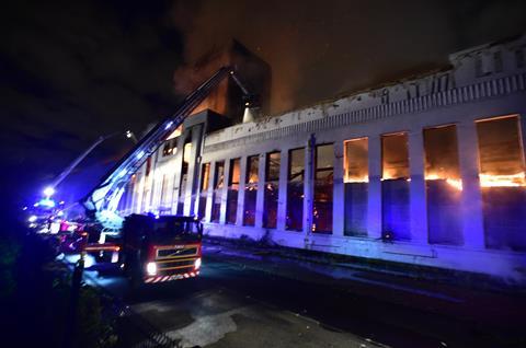 Firefighters douse the burning Littlewoods Building in Liverpool