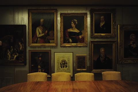 Paintings are gathered together on feature walls, hung on milled aluminium panelling.