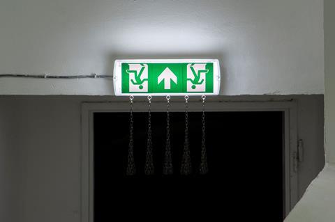 Abbas Zahedi, Exit Sign (2021). Customized exit sign, steel chains and eye bolts, 40 x 40 x 10 cm. Image courtesy of the artist