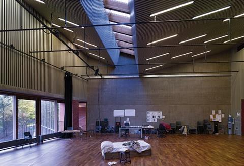 The top-lit rehearsal room is lined in pin-striped acoustic battens.