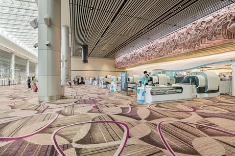 View of security at Changi airport terminal 4 which was designed by Benoy. An immersive media wall by Moment Factory is visible on the right