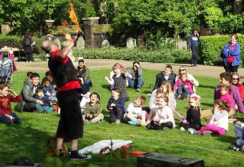 Flame eater at a community party in St George's Gardens